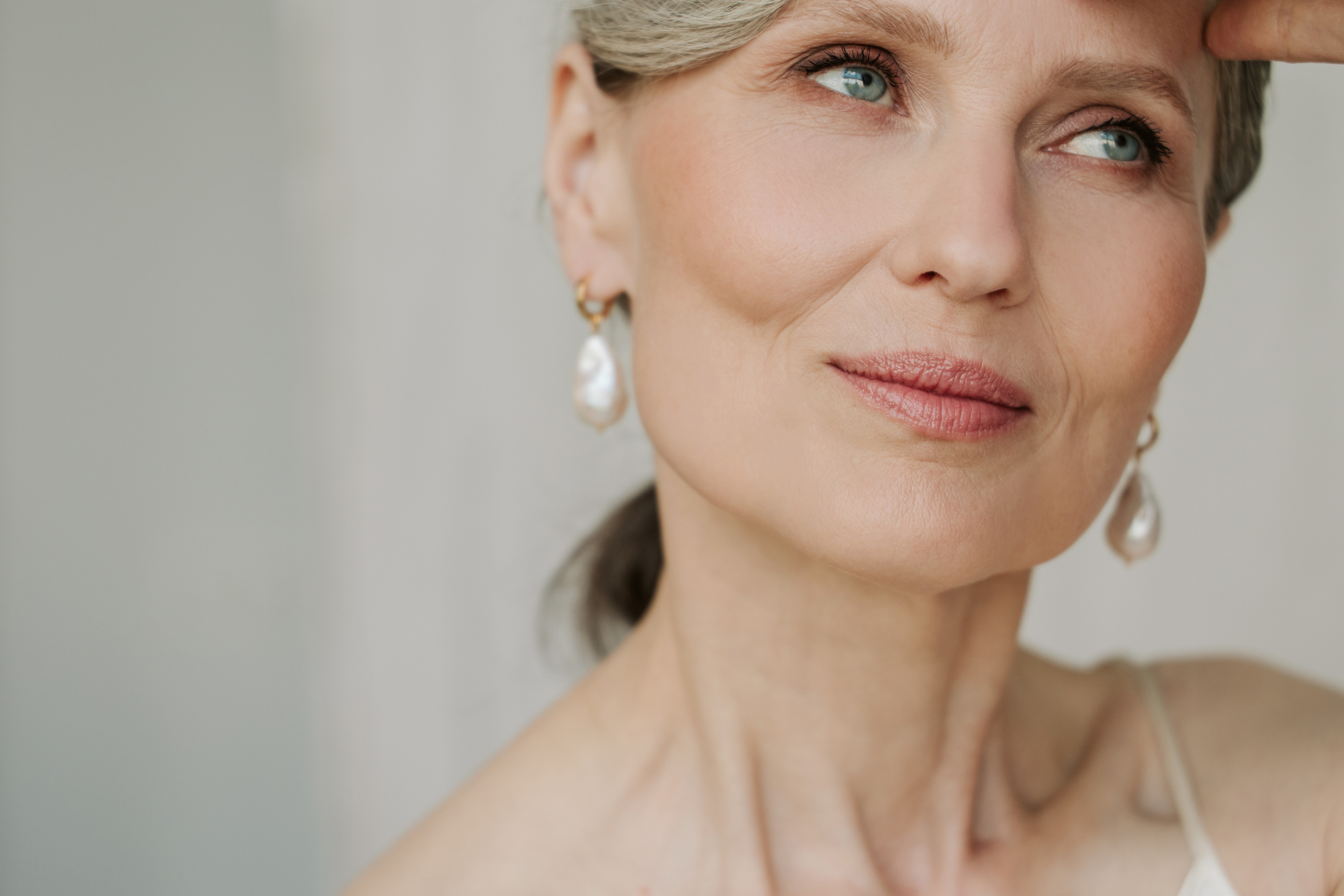 Mature Woman Wearing Pearl Earrings