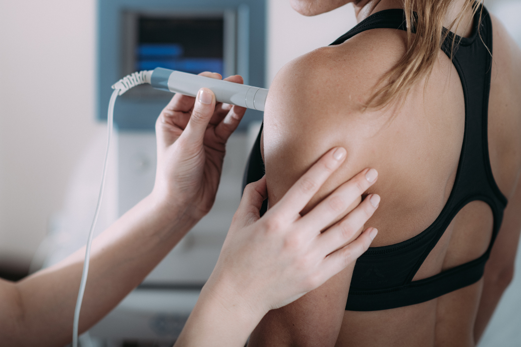 Laser therapy. Physical therapist treating patient's shoulder